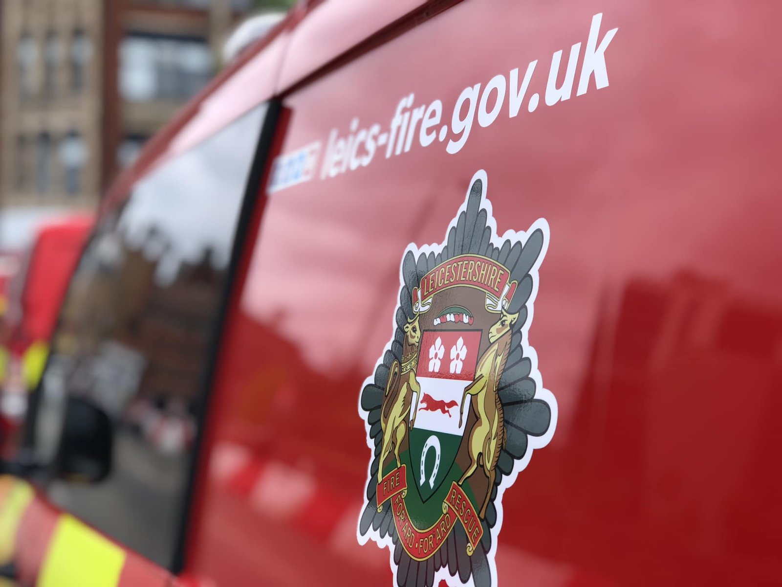 Photo of a Leicestershire Fire and Rescue Service van showing the side of the van with the badge and website address on.